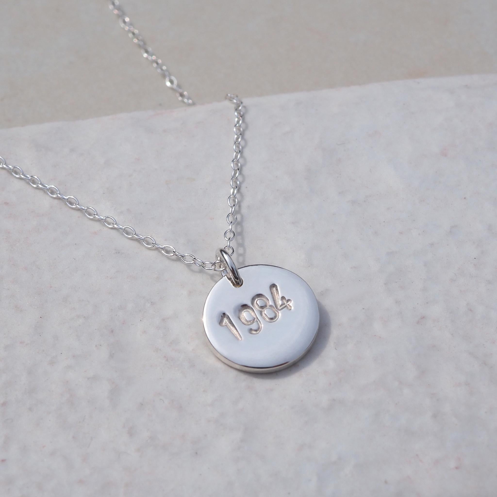 Silver year necklace with hand-stamped dates, perfect for anniversaries and milestones