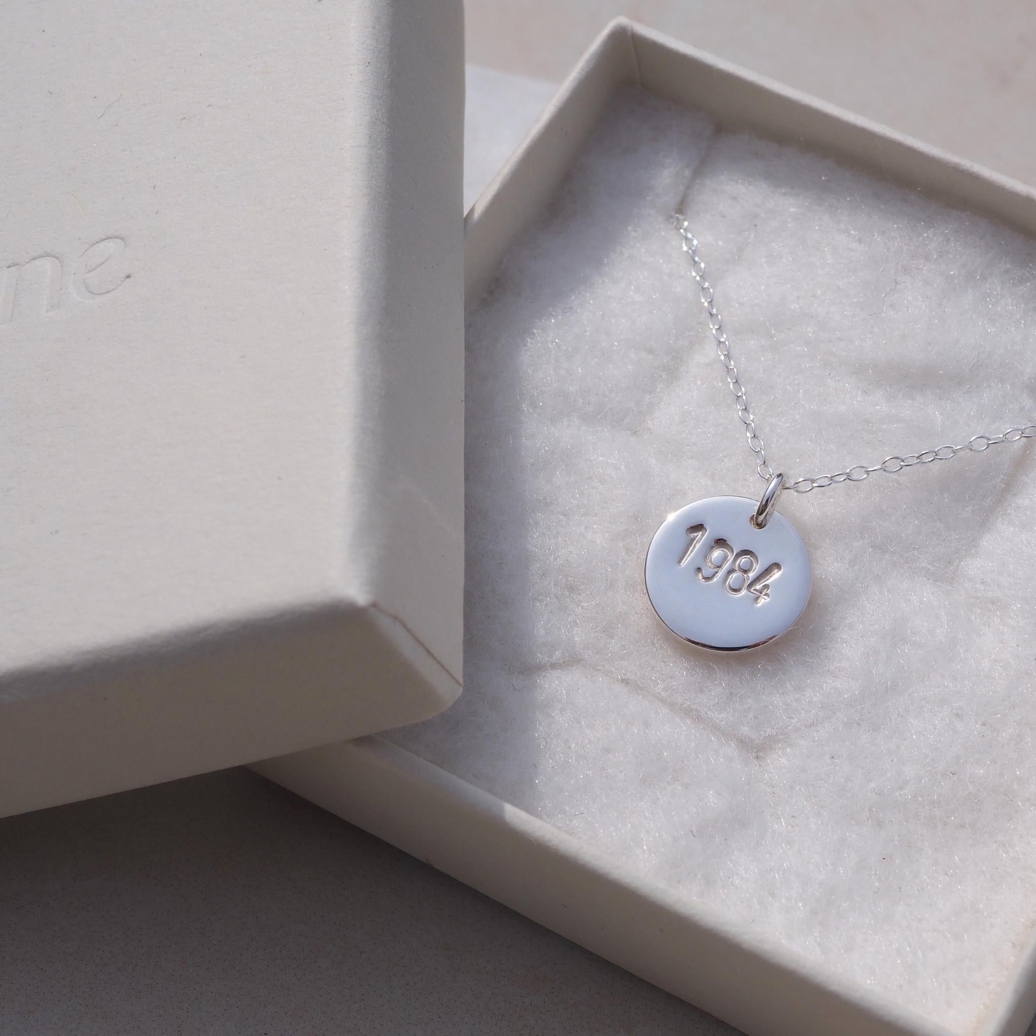 Silver year necklace, hand-stamped with dates, perfect for celebrating milestones