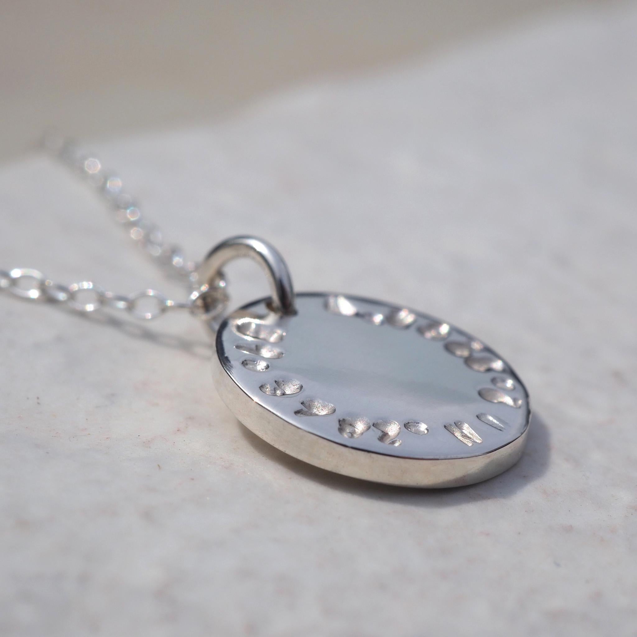 Custom double-sided disc necklace, in sterling silver, hand-stamped with a grid reference to mark a meaningful location