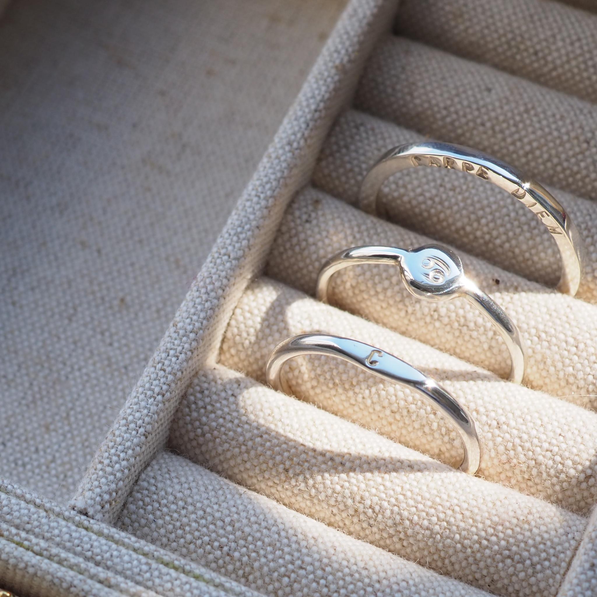 Set of personalised, hand stamped sterling silver rings in a jewellery box