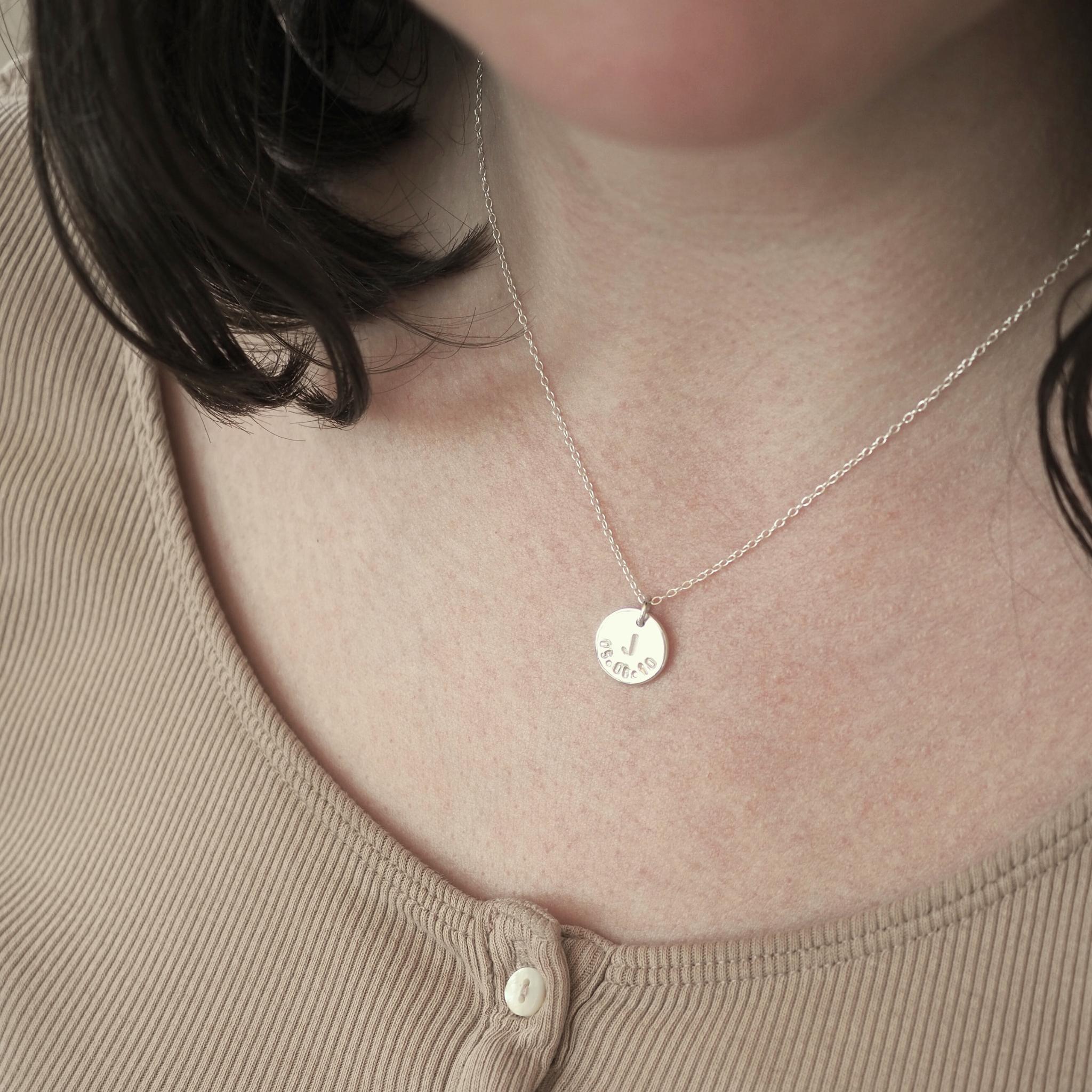 Model wearing a personalised double sided disc necklace in sterling silver