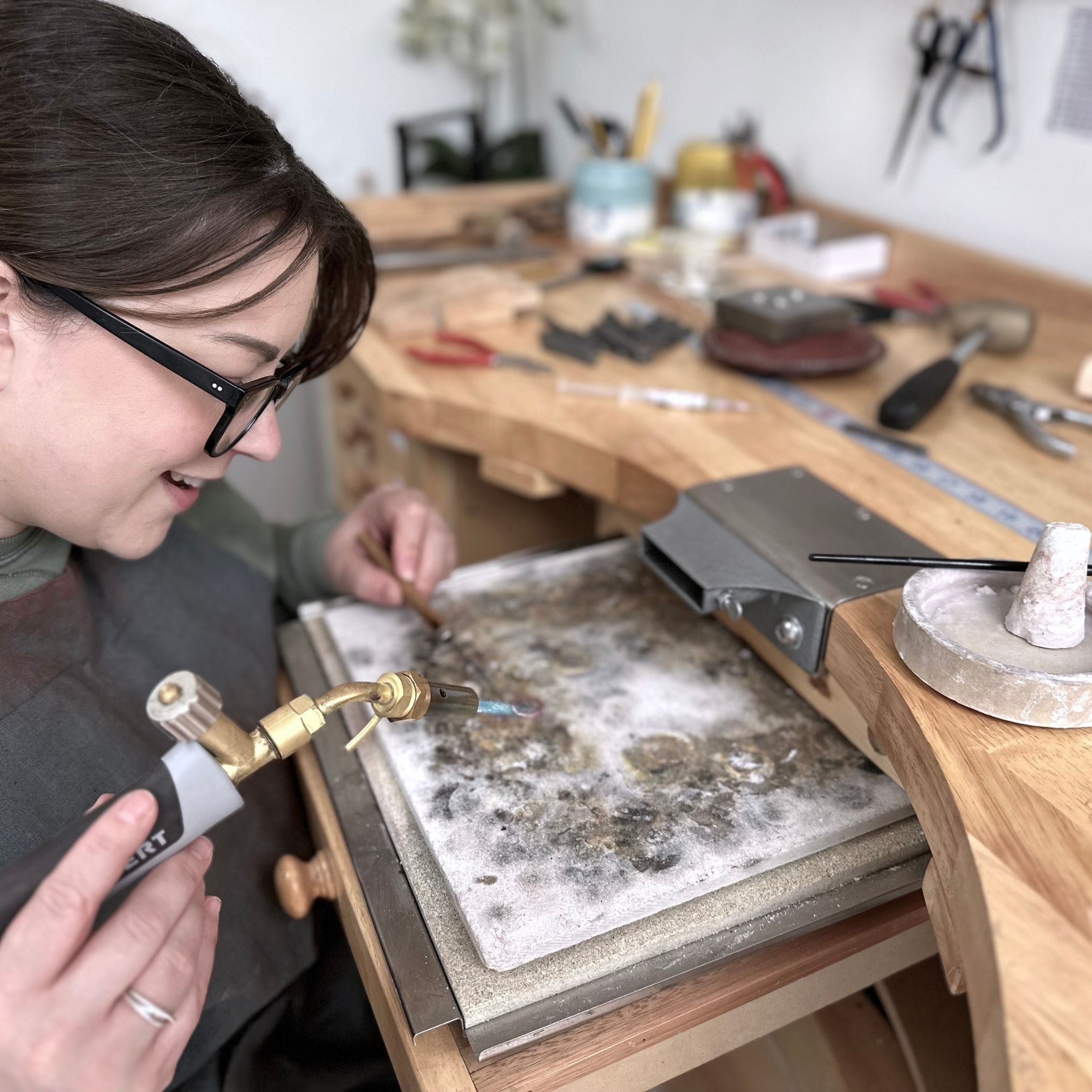 Jeweller handcrafting Organic Zodiac Stud Earrings in studio, using traditional metalsmithing techniques