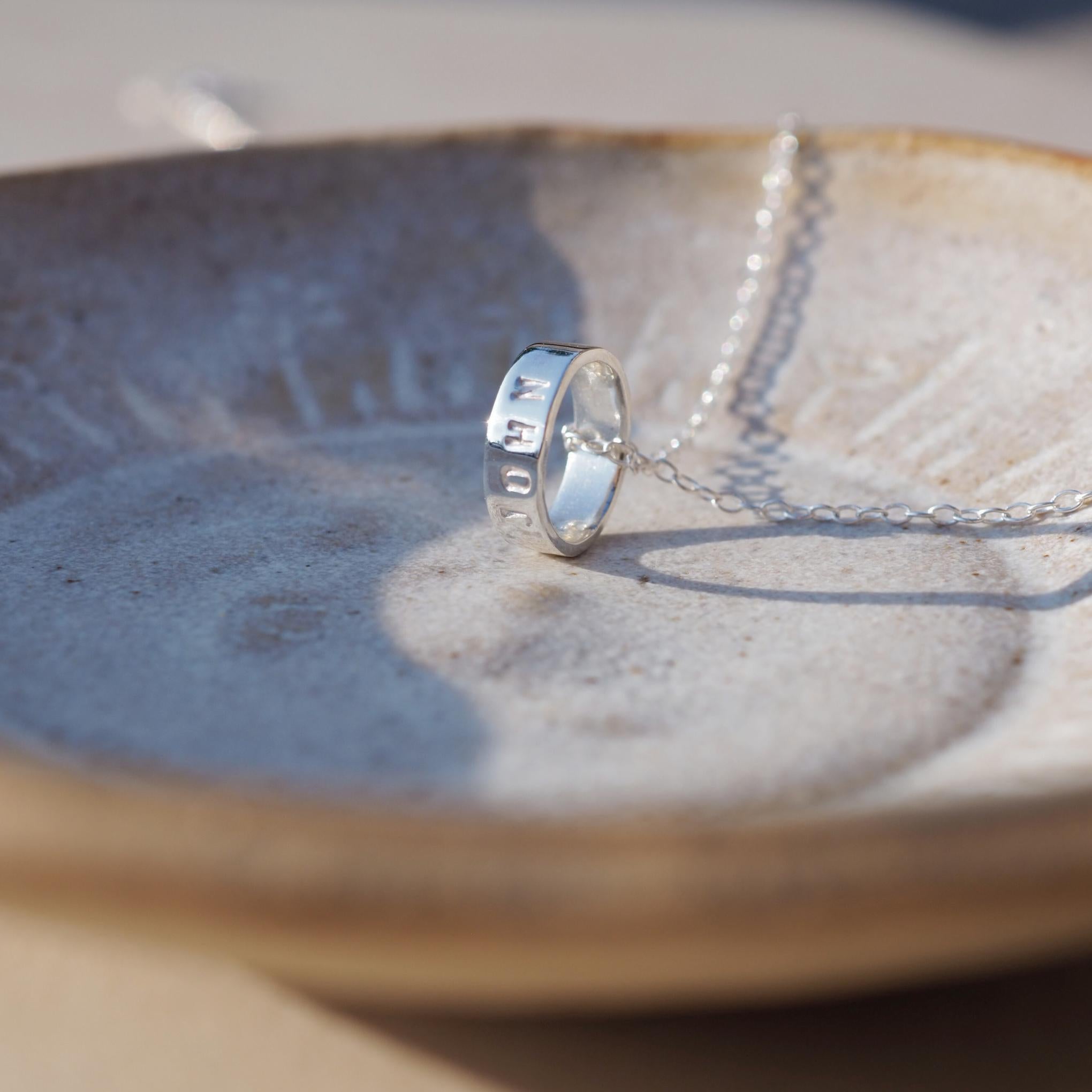 Hand-stamped silver scroll necklace, perfect for personalising with special names or dates