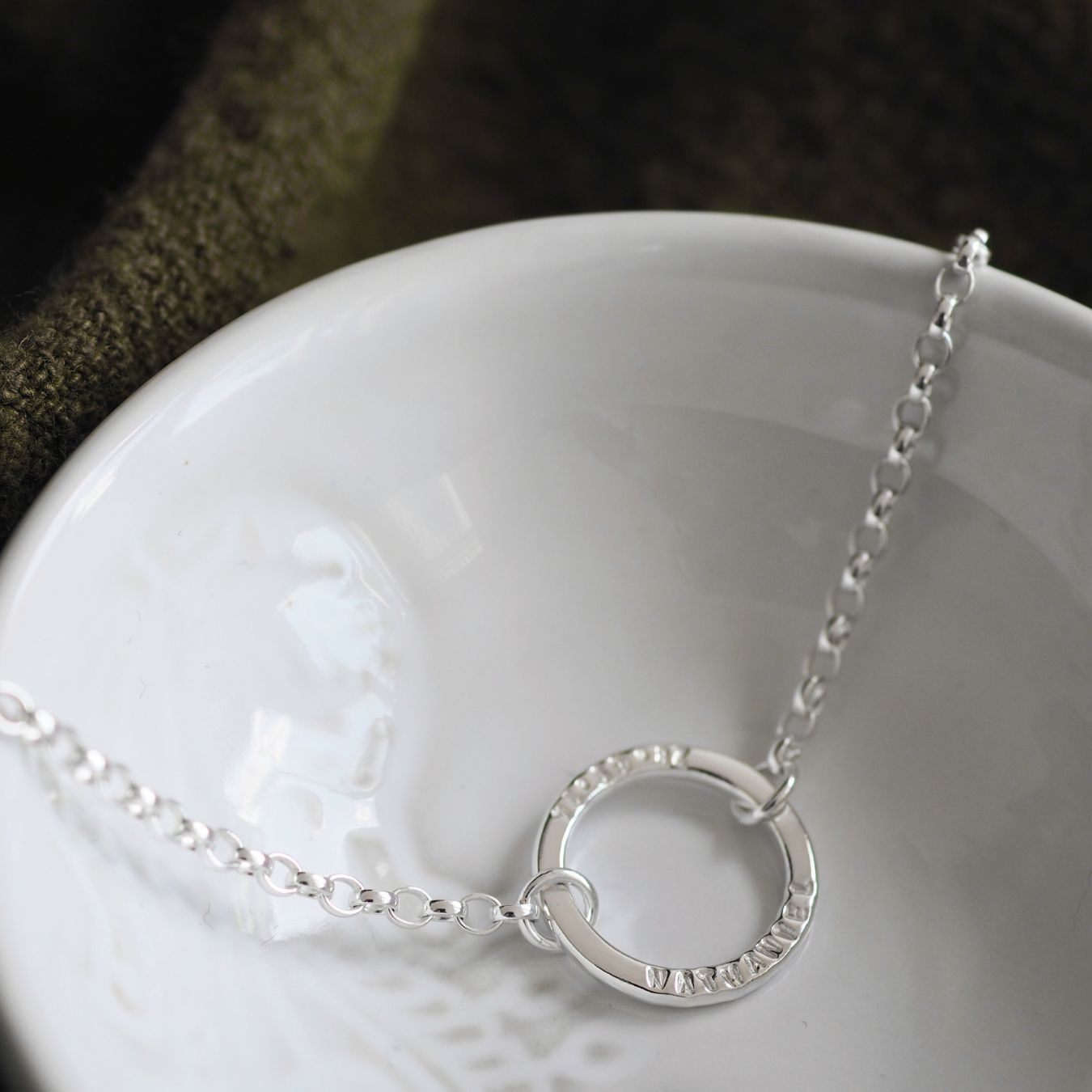 Sterling silver halo bracelet personalised with a handstamped name and date