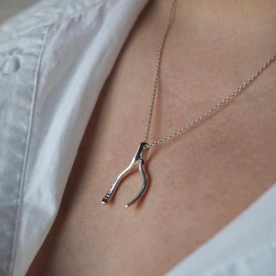 Model wearing the personalised wishbone necklace in sterling silver