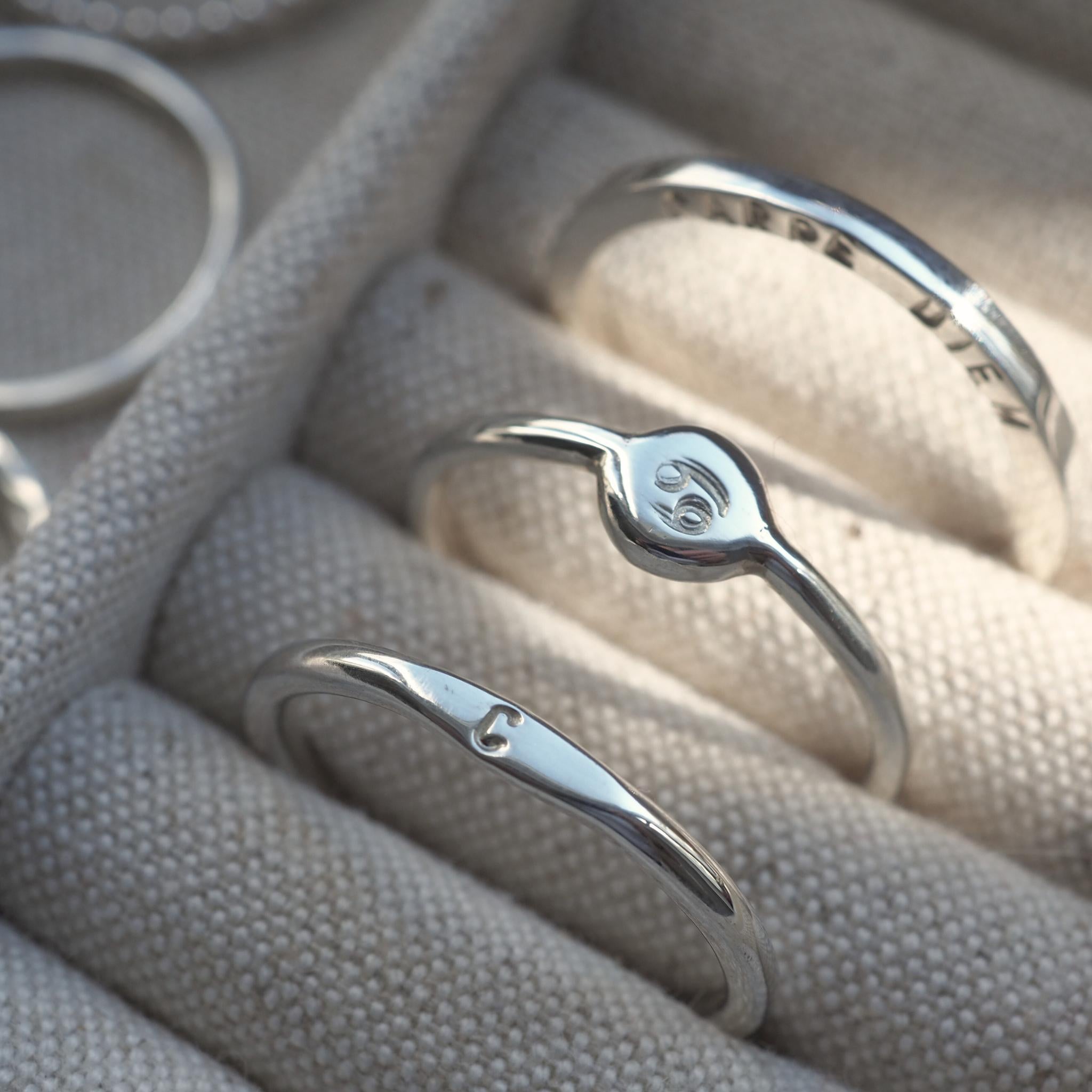 Group of personalised sterling silver ring, personalised with initials, quotes and zodiac signs