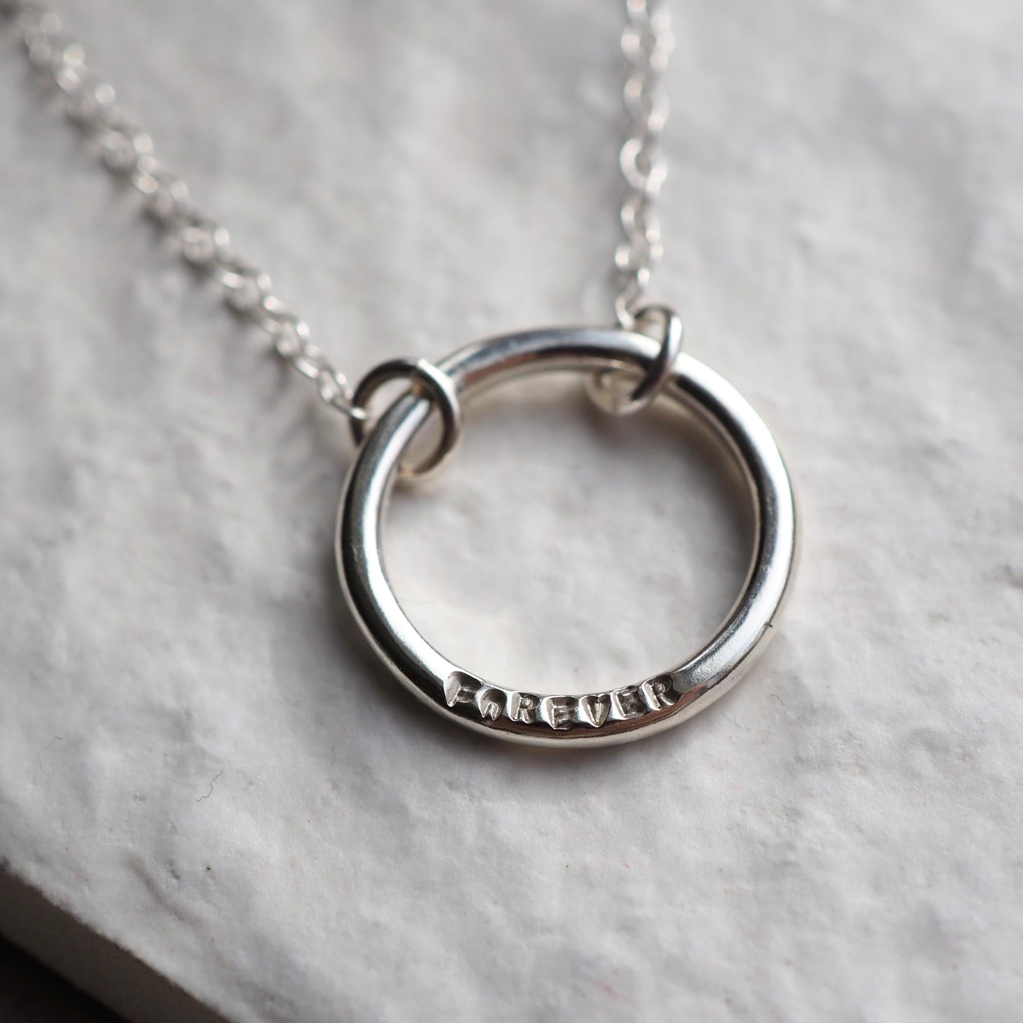 Sterling silver single halo necklace with hand-stamped word
