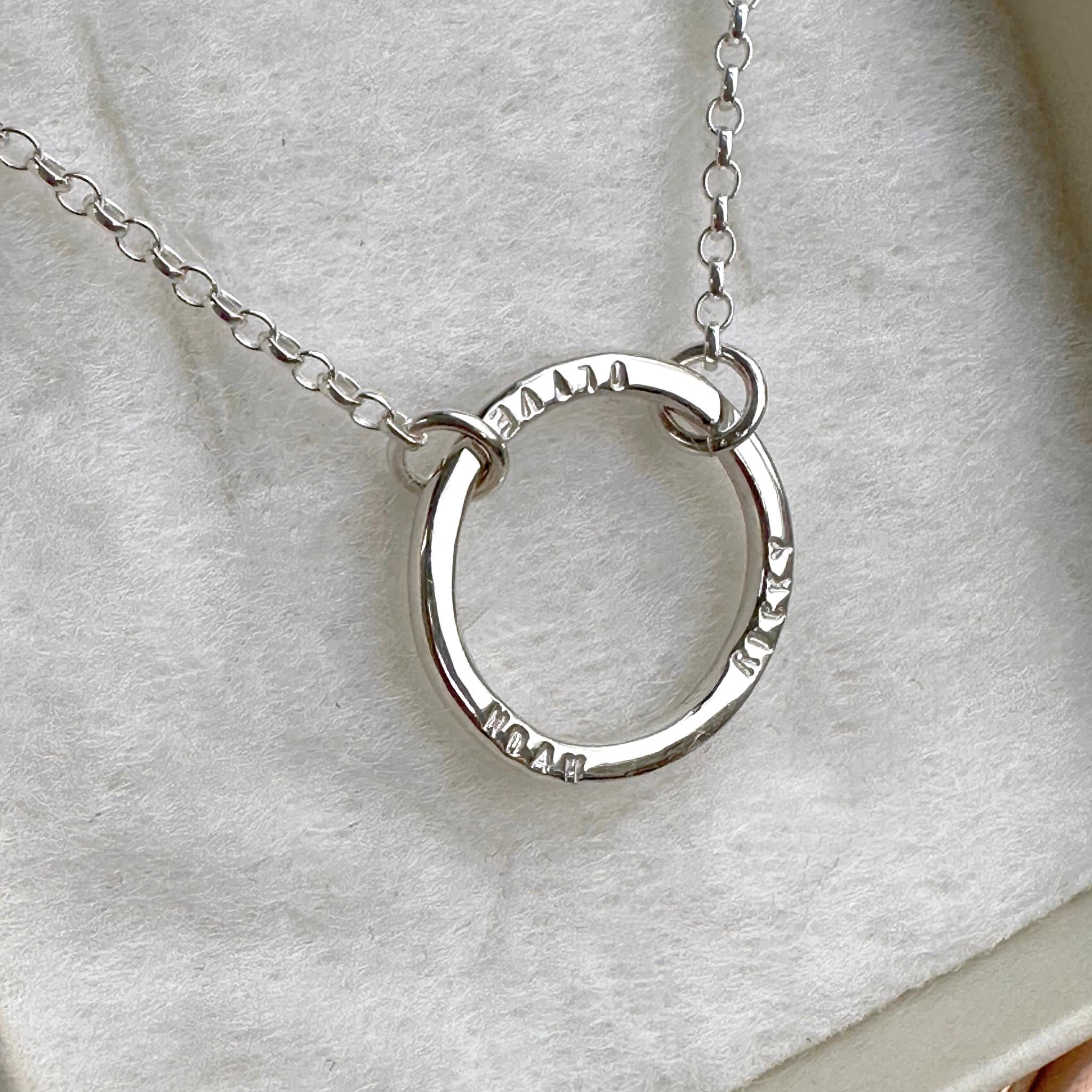 Hand-stamped single halo necklace personalised with hand-stampled names